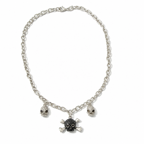 A silver-toned chain necklace featuring three skull and crossbones charms, with the center charm in black and the side charms in silver