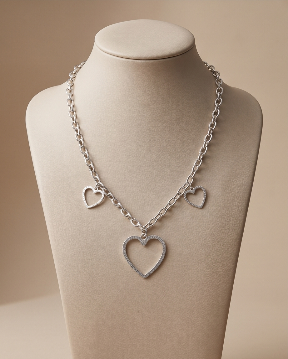 a beige display with heart hammered necklace 