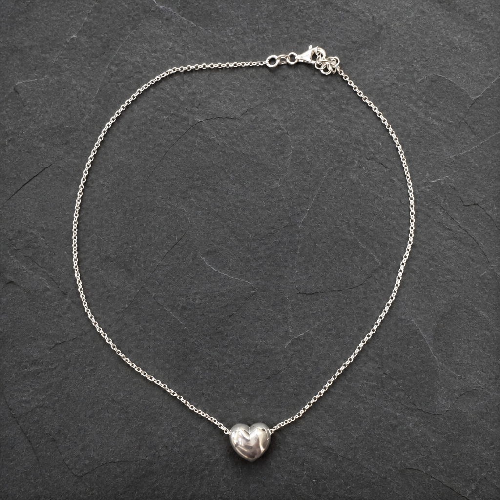 Silver chain necklace with a textured heart-shaped pendant