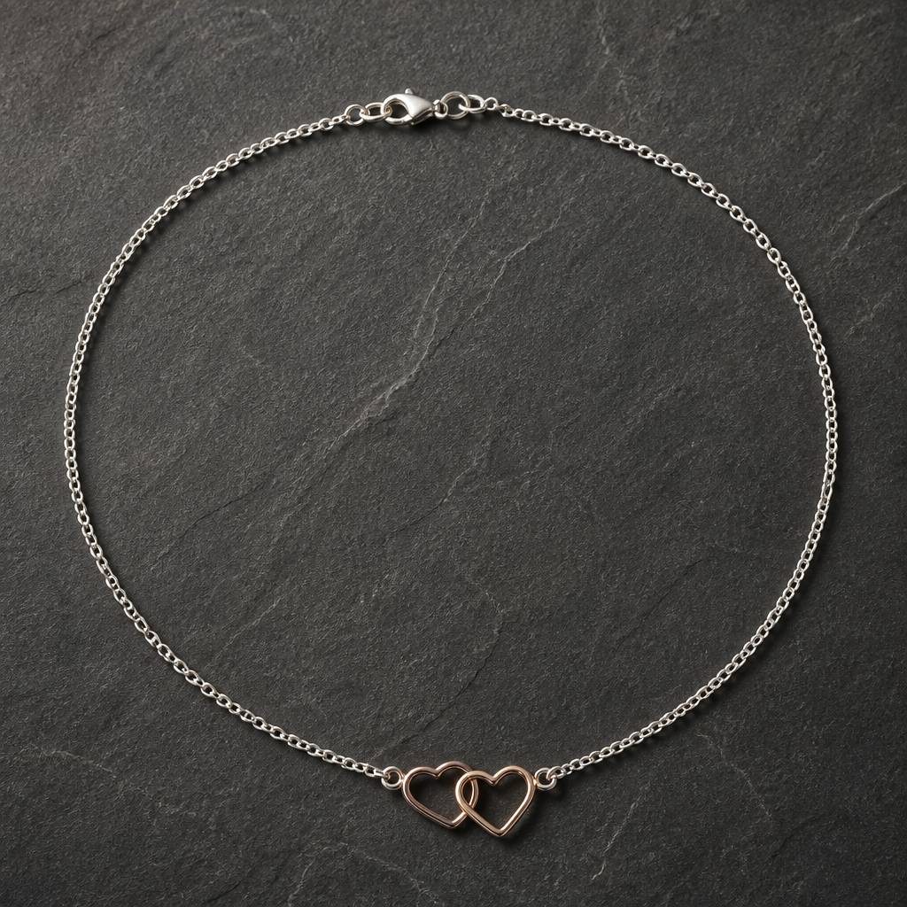 Silver chain necklace with a small interlocking double heart pendant in rose gold