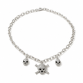 A silver-tone chain necklace featuring three skull charms, with a larger skull and crossbones pendant in the center and two smaller skull charms on either side