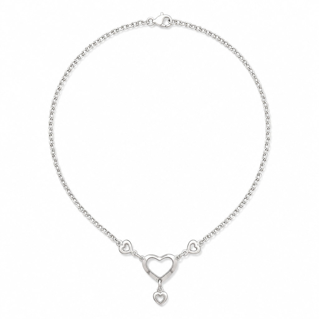 A silver chain necklace featuring three open heart charms, with a larger central heart and a small dangling heart charm