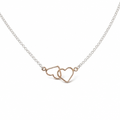 A delicate necklace featuring two interlocking open heart charms in rose gold