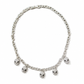 A silver-toned chain necklace featuring five dangling skull charms, each embellished with small clear stones